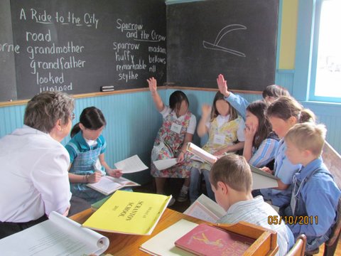 Class recitation at the front of the room