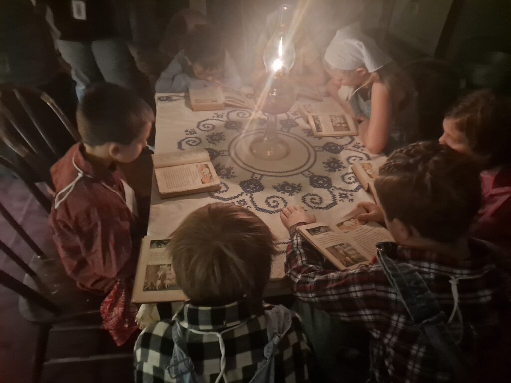 Students reading by oil lamp